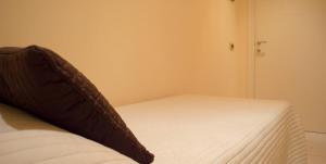 a bed with a pillow on it in a room at Guerrini Hotel in Castiglioncello