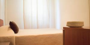 a bedroom with a bed with a pillow on it at Guerrini Hotel in Castiglioncello