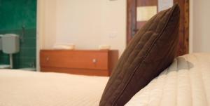 a close up of the top of a bed at Guerrini Hotel in Castiglioncello