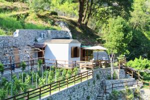a house with a stone wall and a fence at TENUTA BOSCO-Casa Vacanze in Cetara