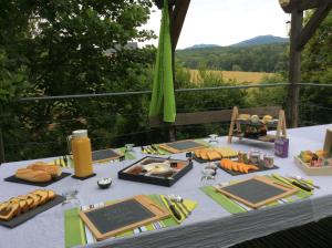 a table with a table cloth with food on it at Aux Neuf Saules in Mortzwiller