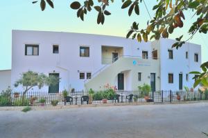 a white building with a staircase in front of it at Xenios Zeus Apartments in Kissamos