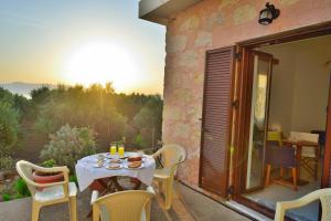 a table and chairs on the patio of a house at Xenios Zeus Apartments in Kissamos