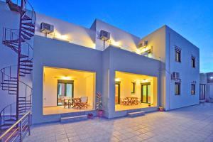 a large white building with lights on it at Xenios Zeus Apartments in Kissamos