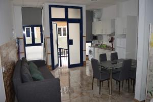a living room with a couch and a table and a kitchen at apartamento agaete Beach 4a in Agaete