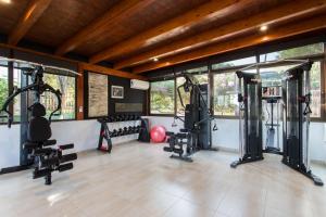 a gym with treadmills and machines in a room at Hotel & Spa Entre Pinos-Adults Only in Es Calo