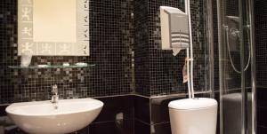 a bathroom with a toilet and a sink at Guerrini Hotel in Castiglioncello