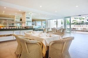 a dining room with a table and chairs at Grupotel Club Menorca in Son Xoriguer