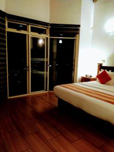 a bedroom with a bed and a dresser at 36 Bed & Breakfast in Kandy