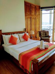 a bed sitting in a bedroom next to a window at 36 Bed & Breakfast in Kandy
