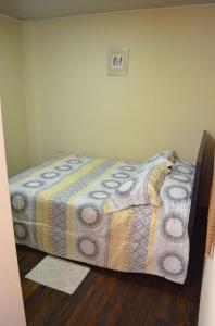 a bedroom with a bed with a quilt on the floor at #4 Private room close to Airport in Alajuela City +11 photos