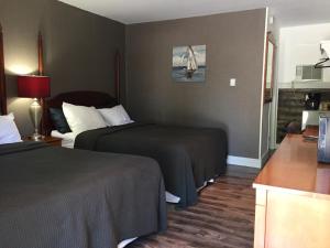 Postel nebo postele na pokoji v ubytování Greenside Motel