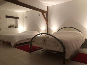 a bedroom with two beds with white sheets and a mirror at Maison en bord de seine in Boissise-le-Roi +11 photos