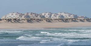 a view of a beach with houses on a hill at Bay House Baleal - Surfboard included in Ferrel