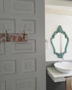 a bathroom with a white door and a sink at Alojamiento San Juan Bautista in Cazorla