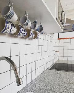 a kitchen with pots and pans hanging on the wall at Alojamiento San Juan Bautista in Cazorla