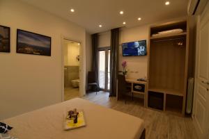 a living room with a table and a bathroom at Effe Home Sorrento in Sorrento