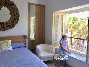 Łóżko lub łóżka w pokoju w obiekcie NATURA SUITE MÁLAGA