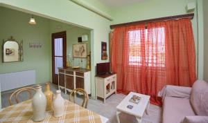 a living room with a table and a couch at Theodora in Patitiri
