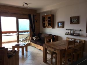 a living room with a table and a couch at La Perle Des Alpes C2 in Villard-sur-Doron