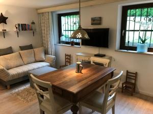 a living room with a wooden table and a couch at Ferienwohnung am Hörnle in Bad Kohlgrub