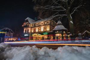 a building with lights in front of it at night at Willa 654 in Szklarska Poręba