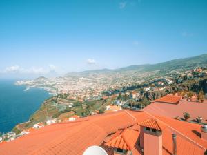 an aerial view of a town with a red roof at Ocean Gardens in Funchal