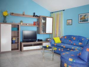 sala de estar con sofá y TV en Apartman I&A, en Porat