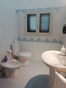 a bathroom with two toilets and a sink at Fontanarossa Airport Home in Catania