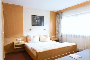 a hotel room with a bed and a window at Appartement Pirmin in Sölden