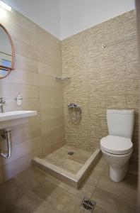 a bathroom with a shower and a toilet and a sink at Theodora in Patitiri +35 photos
