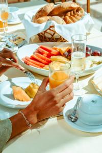 a table topped with plates of food and drinks at Ocean Gardens in Funchal