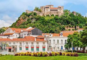 a city with a castle on the hill stock photo at Apartamento central, moderno e luminoso - Self check in in Coimbra