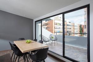 a dining room with a table and a large window at BOGO - 64 in Bogotá