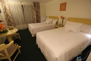 Postel nebo postele na pokoji v ubytování Plaza Mayor Hotel