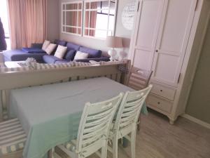 a living room with a table and a couch at 504 Witsand in Bloubergstrand