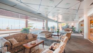 a large living room with couches and tables at Ocean Gardens in Funchal