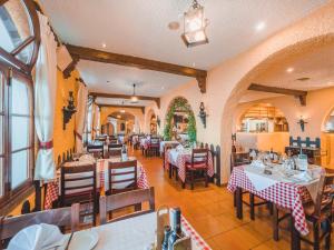 a restaurant with tables and chairs in a room at Ocean Gardens in Funchal