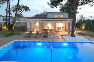 a swimming pool in front of a house at Alexandra Beach Spa Resort in Potos