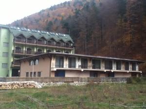 un grande edificio con una montagna sullo sfondo di Ezio House a Braşov