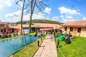 a group of people playing in a swimming pool at Wild Rover Cusco in Cusco