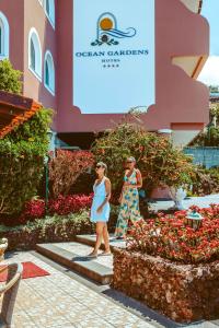 two women walking in front of a building at Ocean Gardens in Funchal