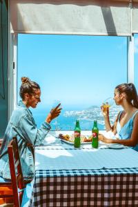a man and woman sitting at a table with food at Ocean Gardens in Funchal