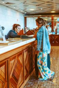 a woman standing in front of a counter at Ocean Gardens in Funchal