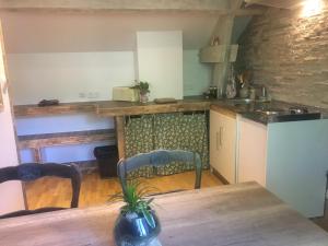 a kitchen with a wooden table and a table and chairs at Domaine de La Clef des Champs in Limeray