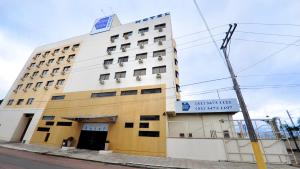 a tall building with a sign on top of it at klein Ville Esteio Br in Esteio