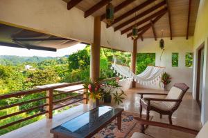 a room with a balcony with a hammock at Villa Numu in Mal País