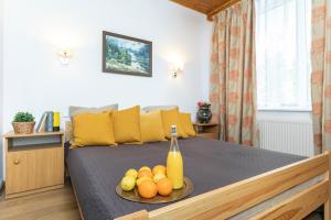 a bedroom with a bed with a plate of fruit on it at Arenda in Karwia