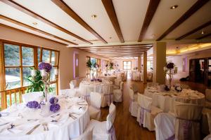a room filled with tables with white table linens at Hotel Scheid in Schriesheim