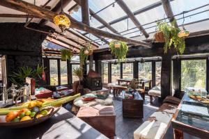 a large room with a kitchen with a bunch of fruits at Wolf Totem Lux Backpacker Villa in Pisac